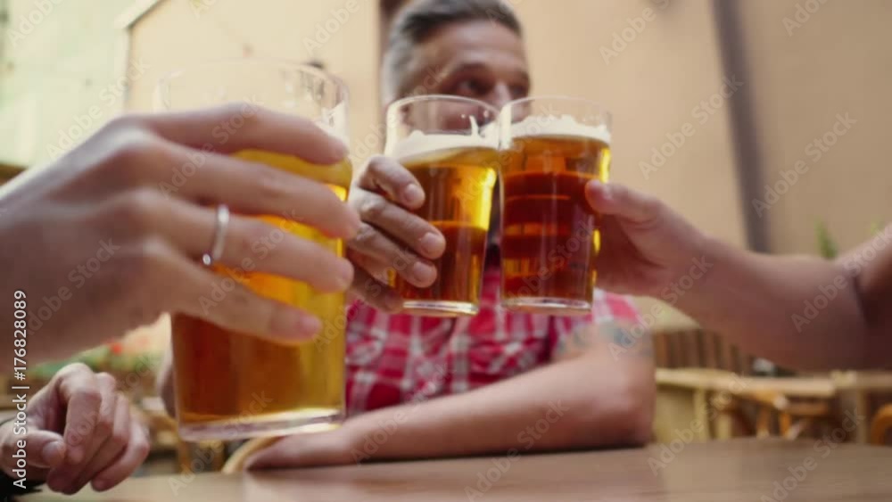 Good old friends drinking beer in a summer garden Good old friends drinking beer in a summer garden