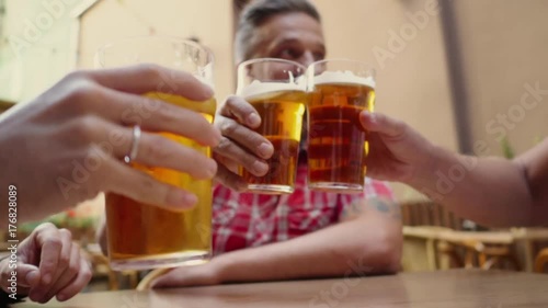 Good old friends drinking beer in a summer garden