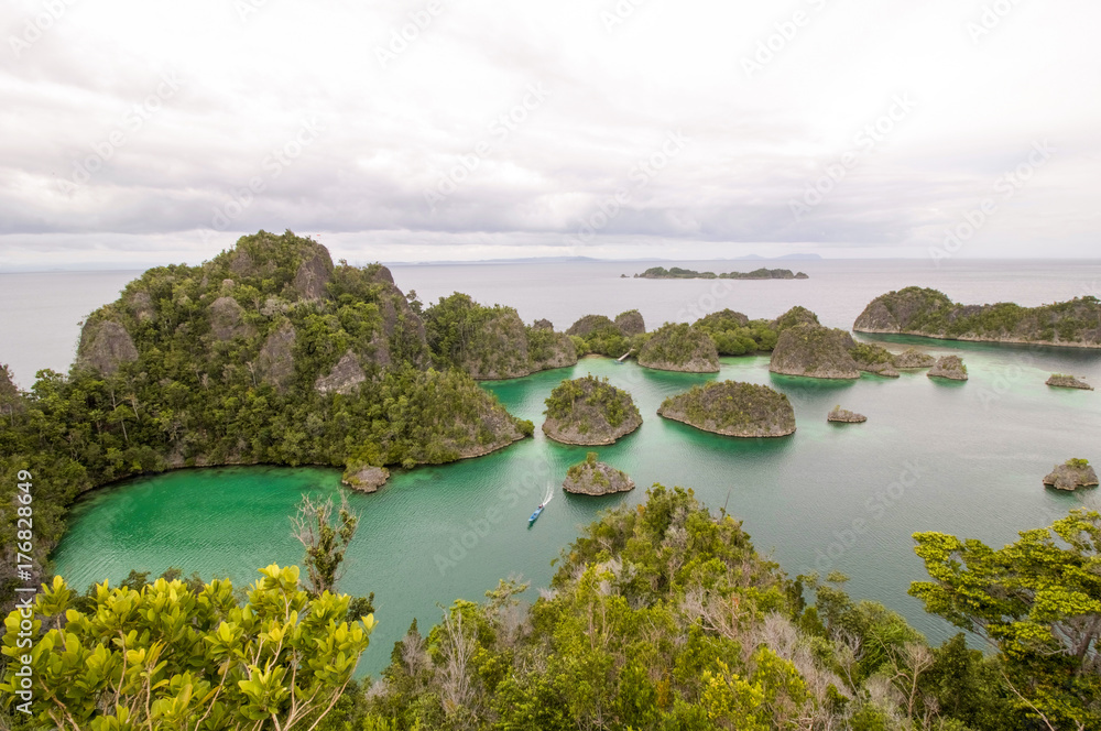 small boat on tipical Pyanemo panorama, raja ampat west papua