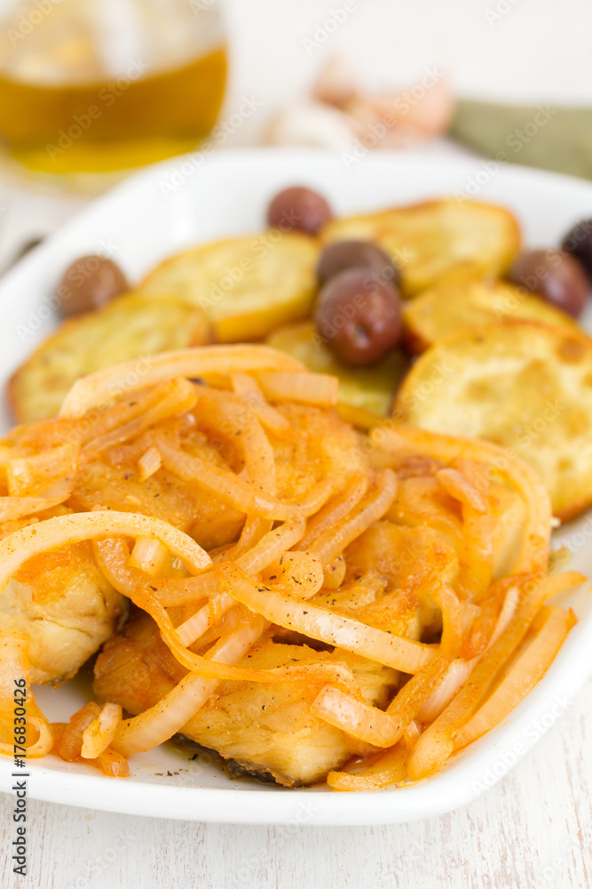fried cod fish with onion and olive oil on dish fried cod fish with onion and olive oil on dish