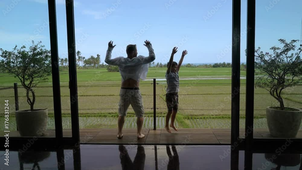 Father going outside with his son and jumping together, steadycam shot
Father going outside with his son and jumping together, steadycam shot