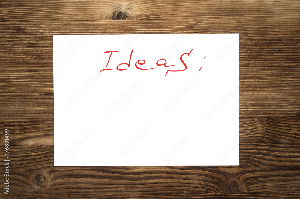 Ideas list paper page on wooden desk table surface with copy space. New ideas concept. Ideas list paper page on wooden desk table surface with copy space. New ideas concept.