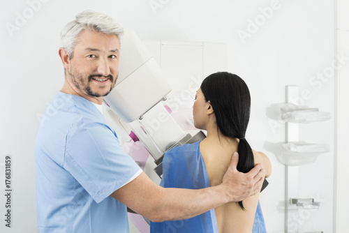 Portrait Of Doctor Assisting Woman Undergoing Mammogram X-ray Te