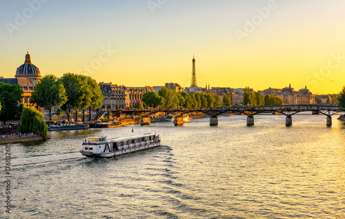 Sunset view of Eiffel tower, Pont des Arts and Seine river in Paris, France