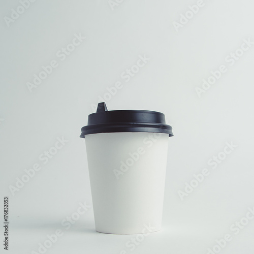 Mockup image of paper cup with cap on clean bacground