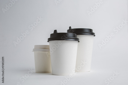 Mockup image of three paper cups with cap on clean bacground
