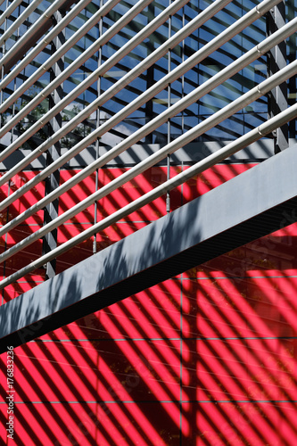 The metal lattice of the architectural element and its shadow on a modern building.