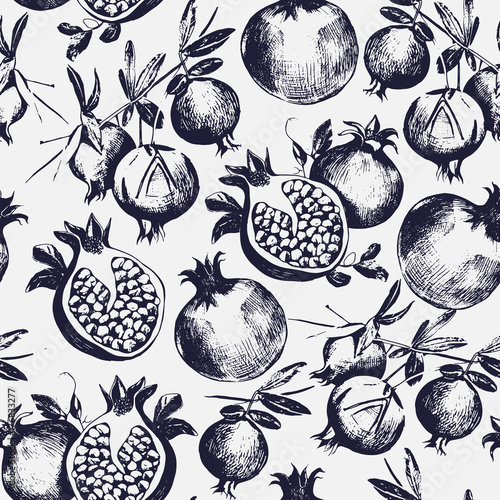 Gorgeous seamless pattern with cut and whole pomegranates growing on branch with leaves. Delicious fresh fruits. Botanical vector monochrome illustration for wrapping paper, textile print, wallpaper.
