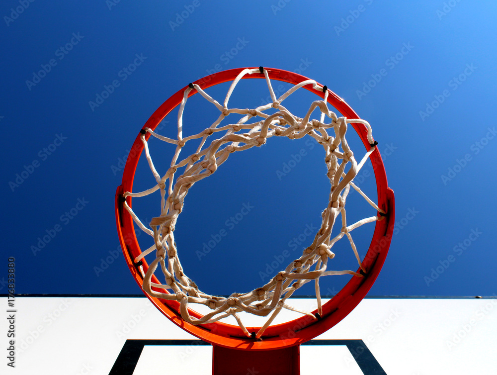 Basketball rim (hoop) seen from below against clear blue sky Basketball rim (hoop) seen from below against clear blue sky