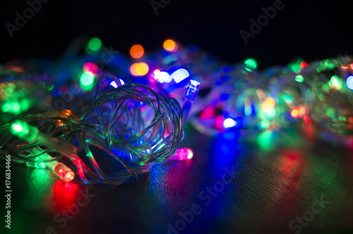 A colorful background with glowing Christmas garland. Selective focus.
