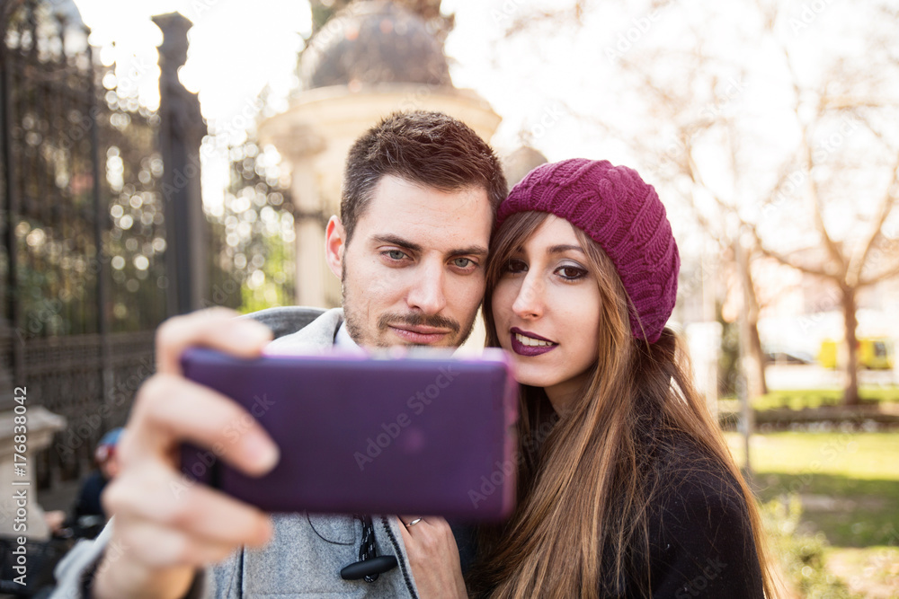 couple taking selfie in the street couple taking selfie in the street