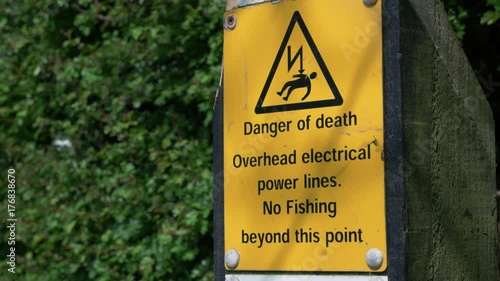 Danger of death, overhead electrical power lines sign along canal in Staffordshire, England.