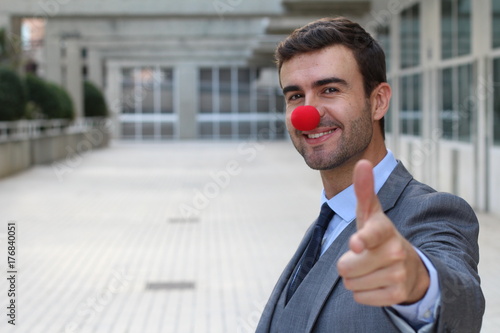 Konstfotografi Businessman with a red clown nose isolated