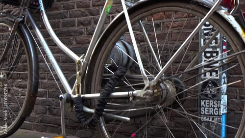 Shooting of a lonely parked ladies' bicycle outside brick wall at Amsterdam's street