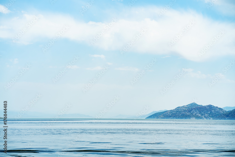 Amazing view on tranquil lake water and mountains landscape. Skadar lake, Montenegro