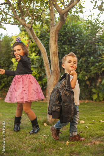 Children dressed up as rockers with leader jacket and make up. Outdoor