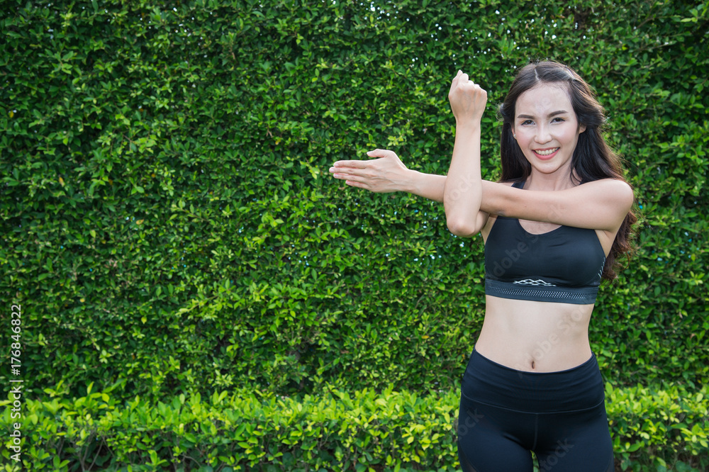 Asian sport woman doing exercise and stretching by yoga on the grass in the garden with copy space for text Asian sport woman doing exercise and stretching by yoga on the grass in the garden with copy space for text