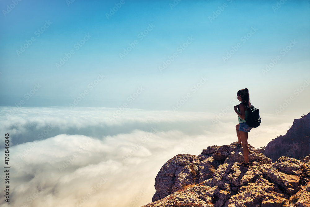 Happy Woman raised hands at sunset mountains