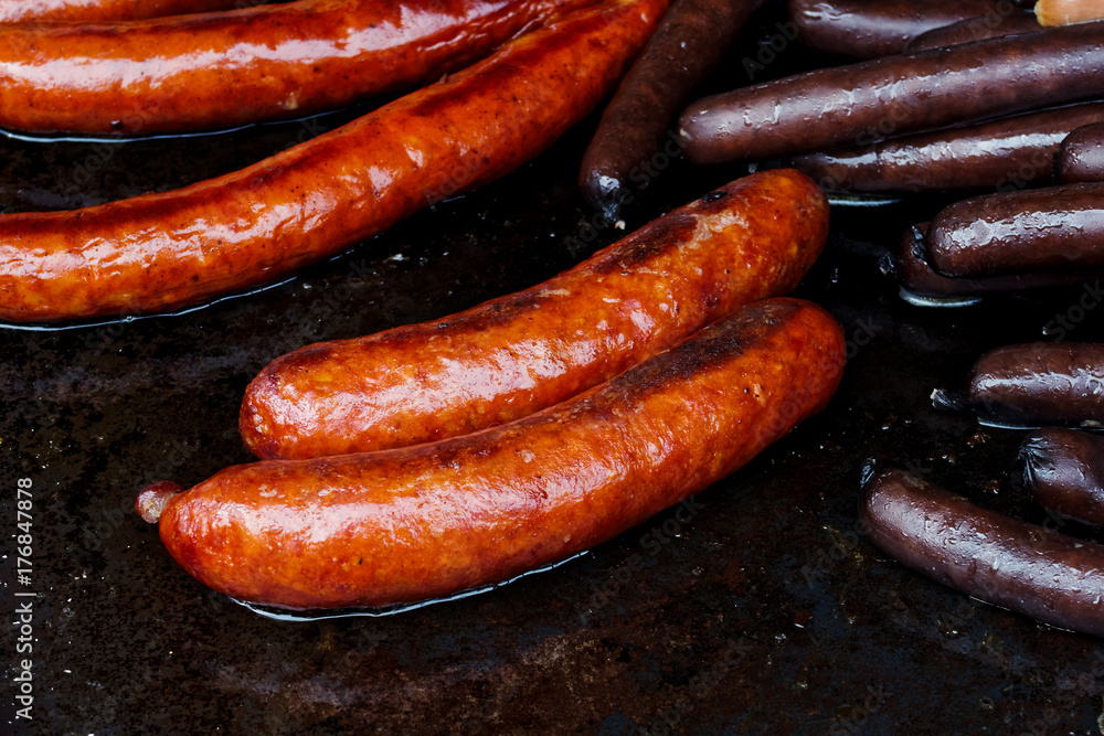 Paprika bratwurst sausages on cast iron griddle. Paprika bratwurst sausages on cast iron griddle.