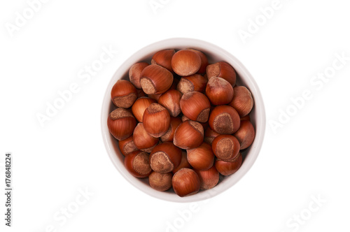 Nuts in a white bowl isolated on white background, top view