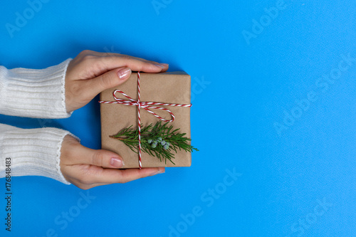 Woman hands holding a Christmas gift box. Christmas presents and New Year. Handmade