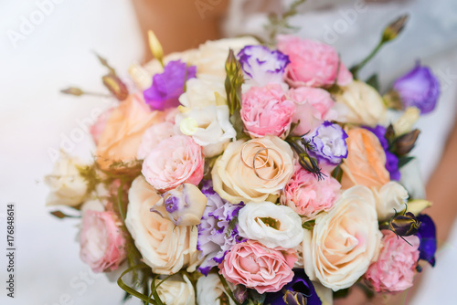 bridal bouquet of bride in the rays of sunlight  engagement rings lie on flowers