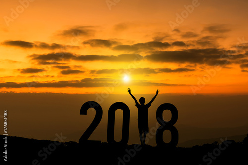 Happy new year 2018 concept, Silhouette a man feel successful and step in to the future on the mountain