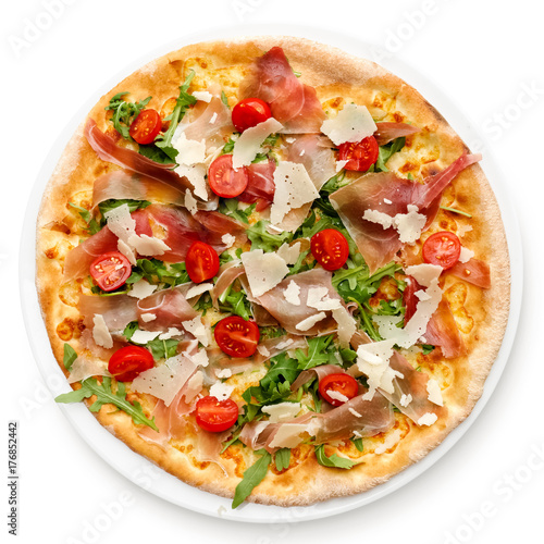 Prosciutto pizza with cherry tomatoes and rucola isolated on white from above.
