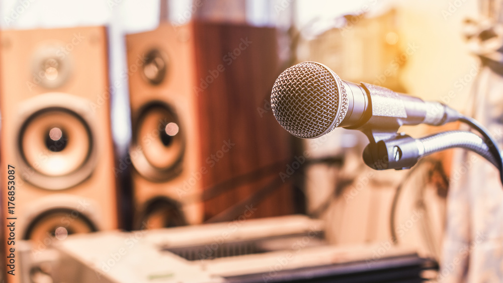 Obraz premium Microphone on a stand with audio mixer in the control room audio system.