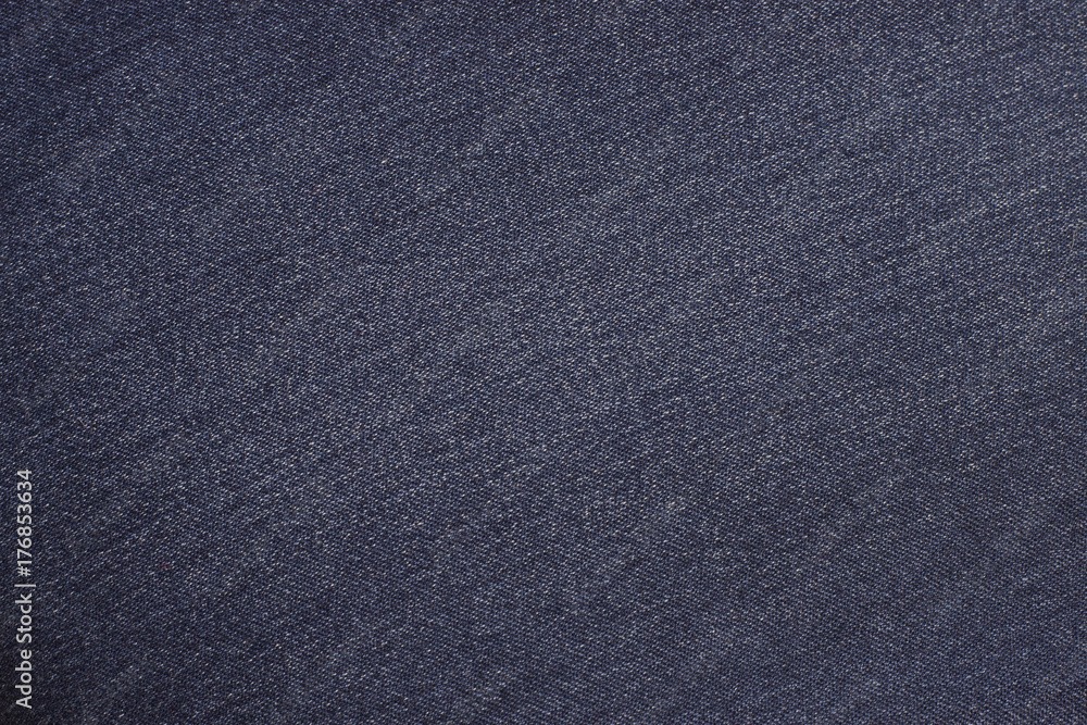 The texture of the jeans is blue. Background of blue jeans material. The texture of the jeans is blue. Background of blue jeans material.
