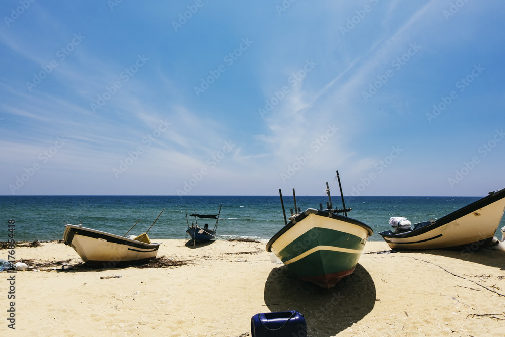 Beautiful scenery, traditional fisherman boat moored over beautiful sea view and sandy beach under bright sunny day