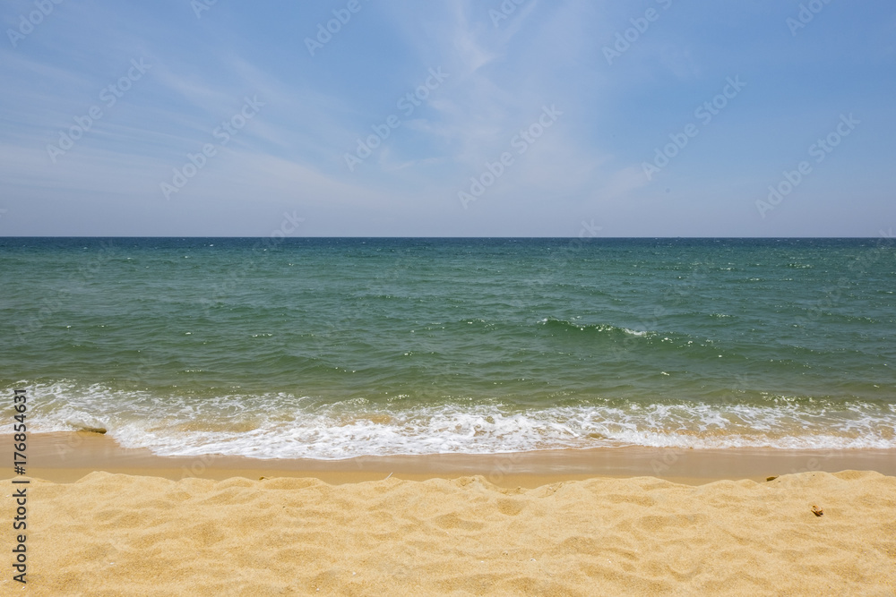 Vacation and peace concept.Beautiful tropical beach, soft wave hitting sandy beach under brighter sunny day Vacation and peace concept.Beautiful tropical beach, soft wave hitting sandy beach under brighter sunny day