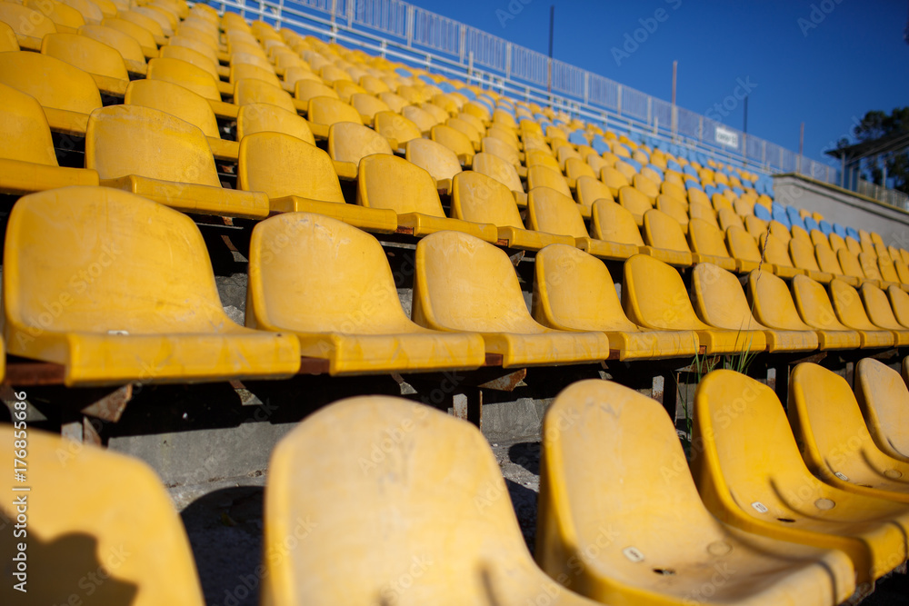 Fototapeta premium yellow chairs at a sports stadium