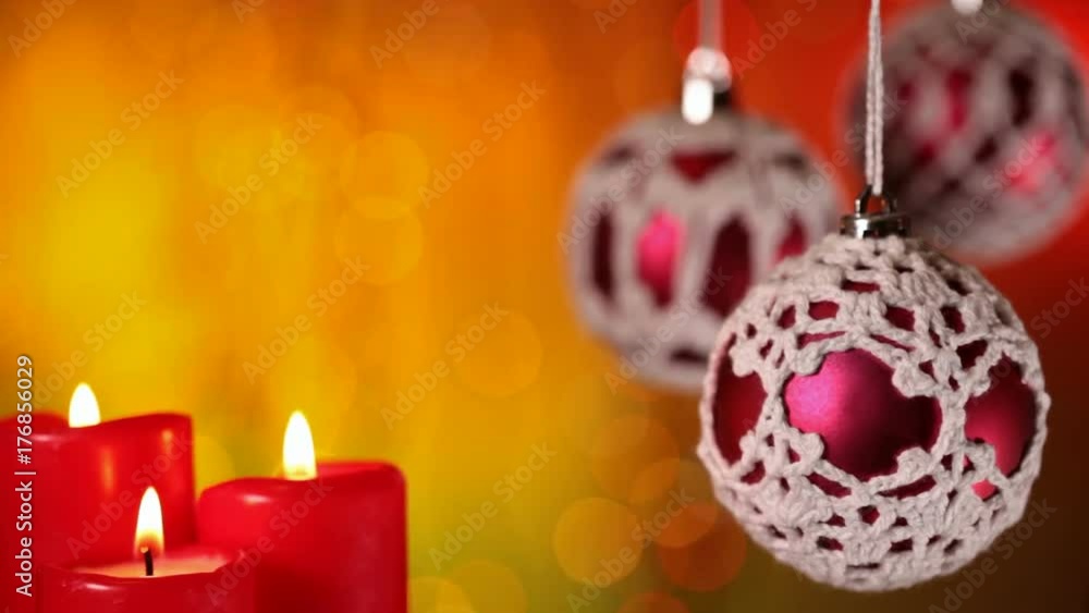 Beautiful christmas ornaments and candles in front of warm colored blurry xmas lights background - closeup with copyspace Beautiful christmas ornaments and candles in front of warm colored blurry xmas lights background - closeup with copyspace