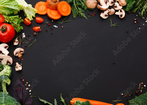 Plenty of fresh vegetables on black background with copy space