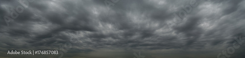Dark clouds before a thunderstorm, tornado, hurricane, in the vast sky. Dramatic sky background photo