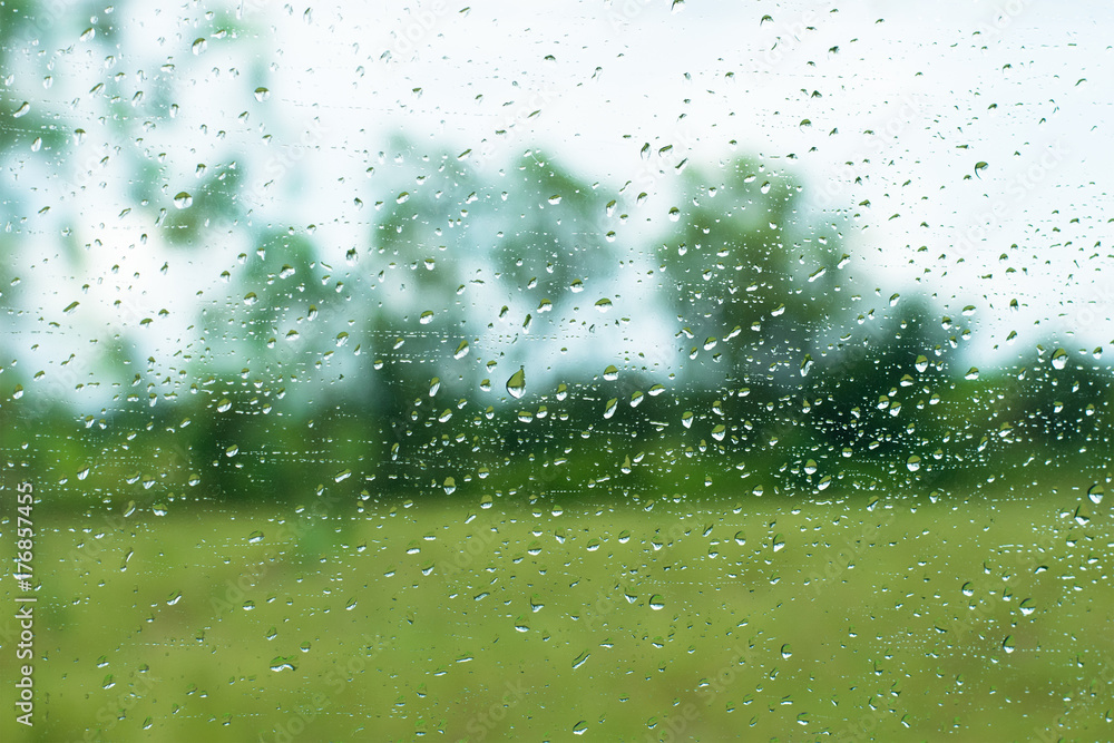 Rain drops on glass surface and outdoor background