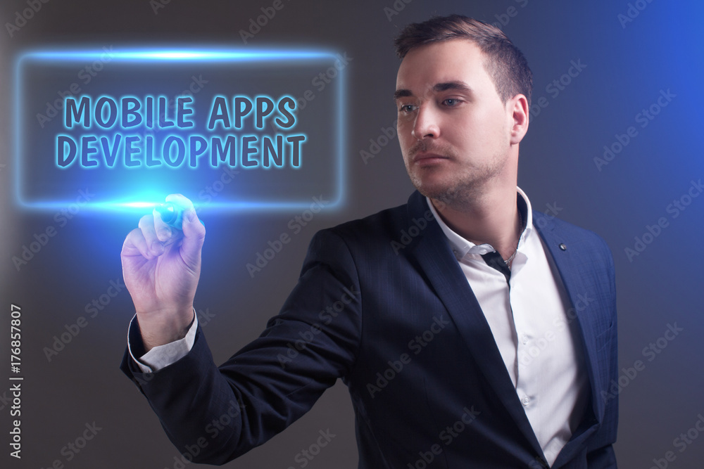 The concept of business, technology, the Internet and the network. Young businessman showing inscription: Mobile apps development