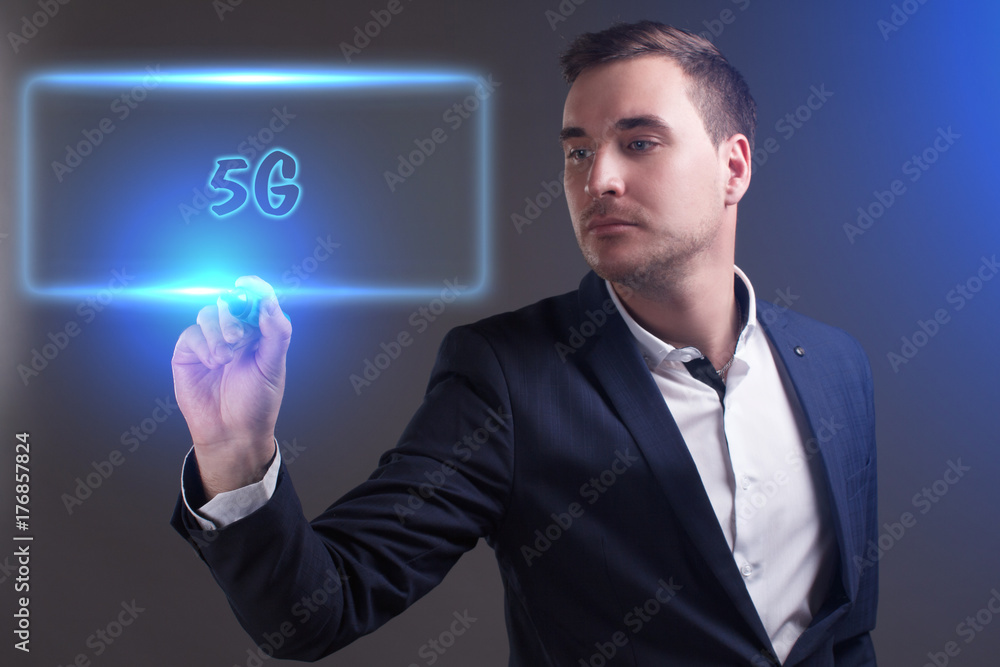 The concept of business, technology, the Internet and the network. Young businessman showing inscription: 5G The concept of business, technology, the Internet and the network. Young businessman showing inscription: 5G