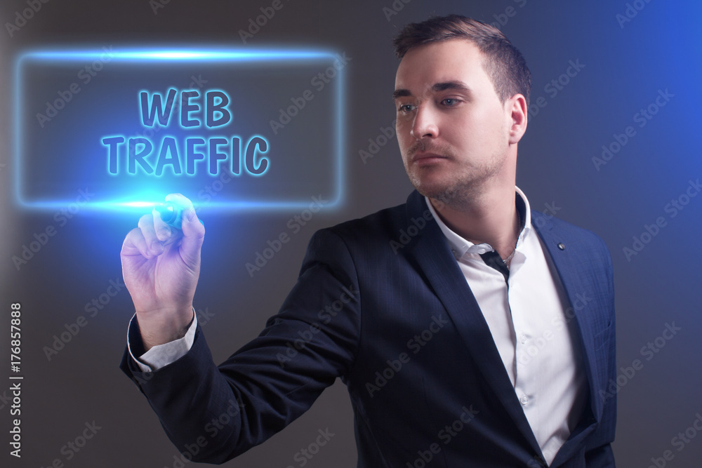 The concept of business, technology, the Internet and the network. Young businessman showing inscription: Web traffic The concept of business, technology, the Internet and the network. Young businessman showing inscription: Web traffic