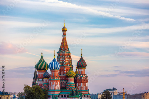 A colorful church, a symbol of the city and country on the background of houses and sunset clouds at dusk and nobody around. St. Basil's Cathedral on Red Square, Moscow, Russia.
