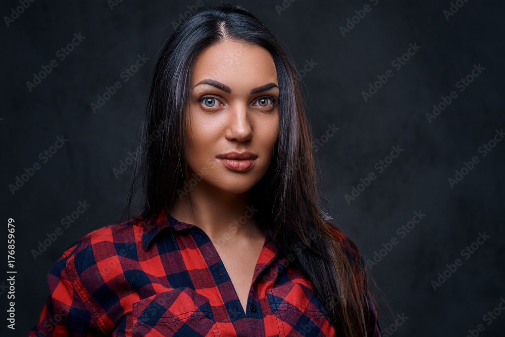 Fototapeta premium A woman dressed in a red fleece shirt over grey background.