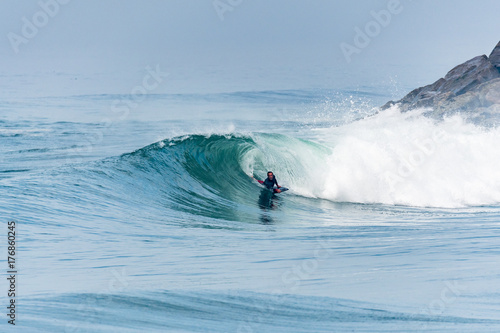 Bodyboarder surfing ocean wave