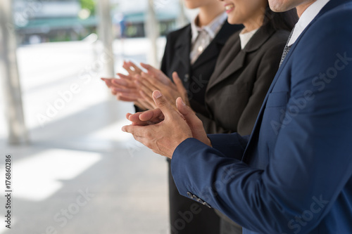 business people clap their hands to congratulate the signing of an agreement or contract between their companies. success, dealing, greeting and partner concept.