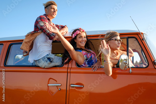 Hippie friends in a van on a road trip © Nejron Photo