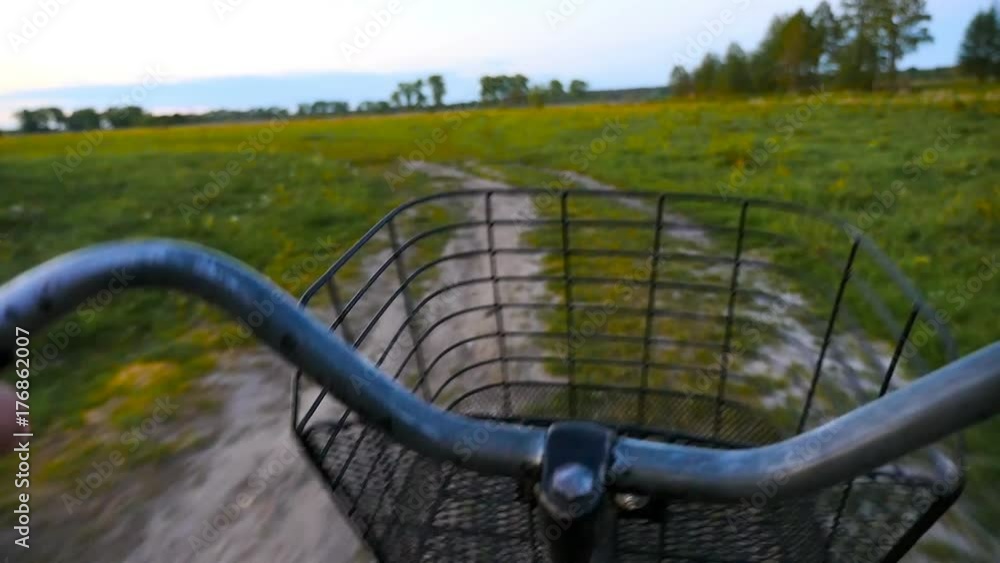 Riding a bike along the beautiful rural road. Evening, sunset Riding a bike along the beautiful rural road. Evening, sunset
