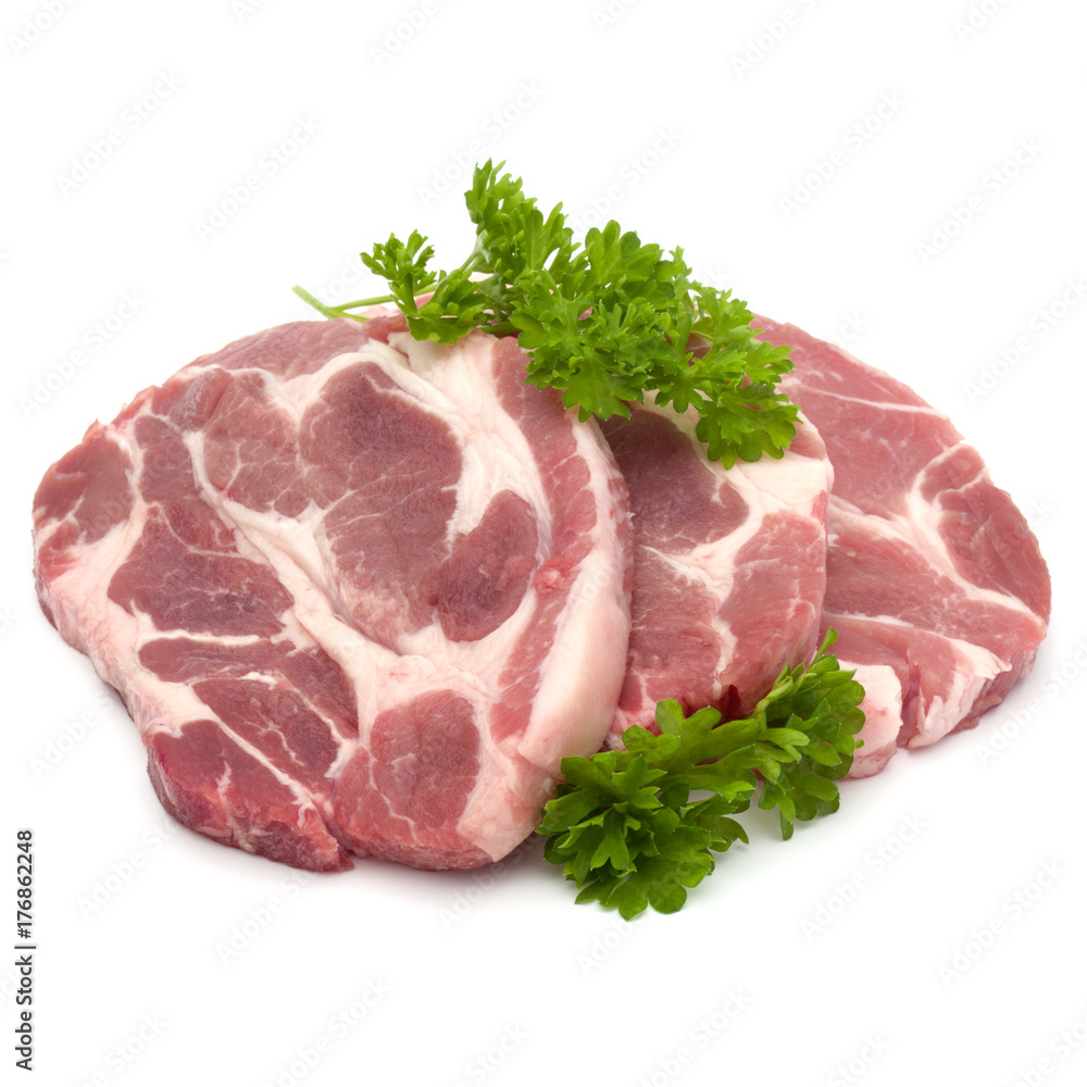 Raw pork neck chop meat with parsley herb leaves garnish isolated on white background cutout Raw pork neck chop meat with parsley herb leaves garnish isolated on white background cutout