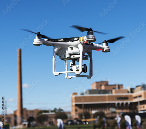 Drone flying low with hospital building in the background
