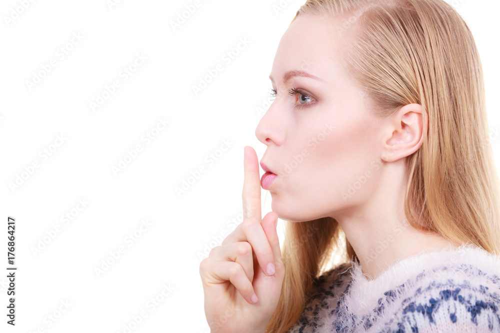 Young blonde woman making silence gesture Young blonde woman making silence gesture