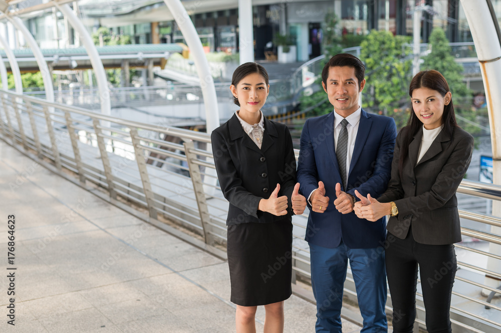 business man and business woman smile and show thumb up two hand at the city, successful concept business man and business woman smile and show thumb up two hand at the city, successful concept